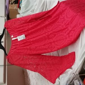 Salmon colored lace dress with sheer asymmetrical lace sleeves.